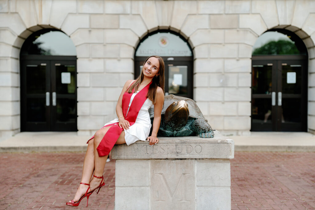 UMD Graduate posed with Testudo wearing her graduation stole