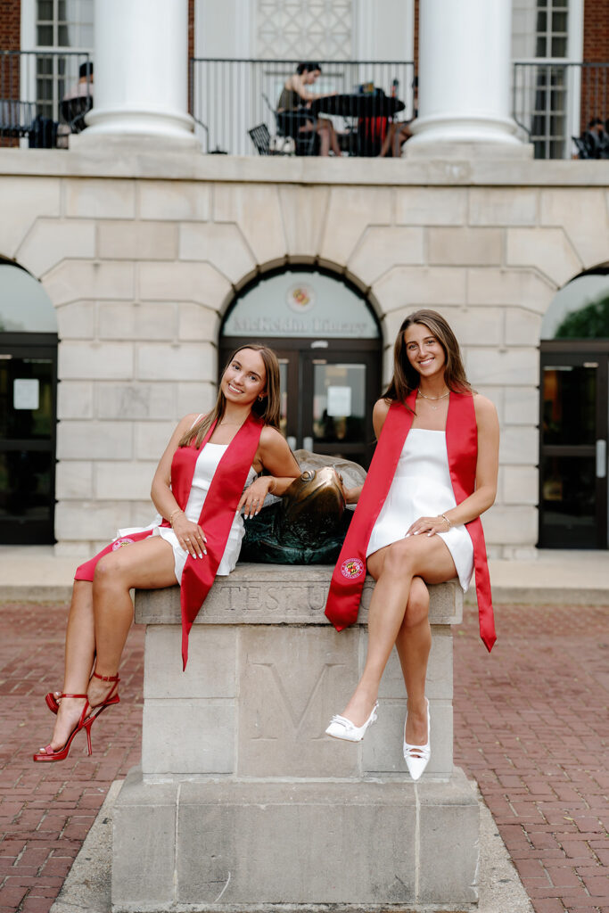 The University of Maryland College Park, Maryland Grads posed with Testudo statue in front of the McKeldin Mall Library