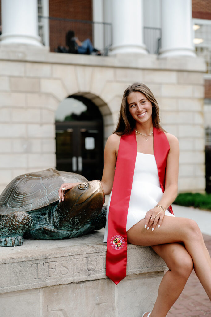 UMD Graduate posed with Testudo wearing her graduation stole